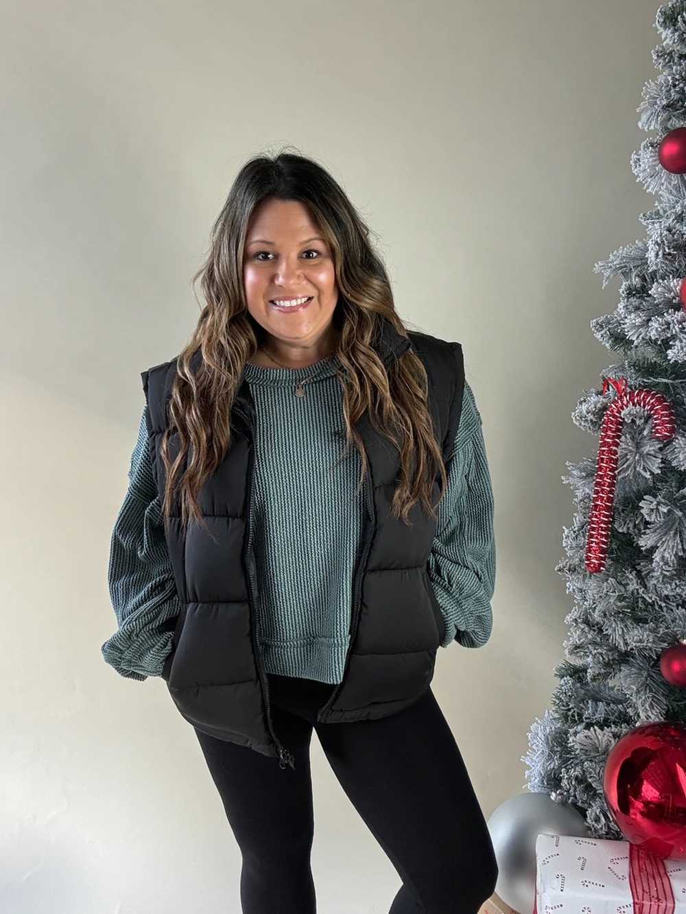 Black Puffer Vest with Green Knit Sweater